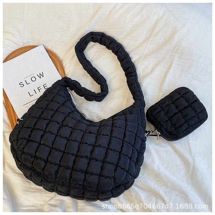 Quilted Crescent Shoulder Bag in black, front view